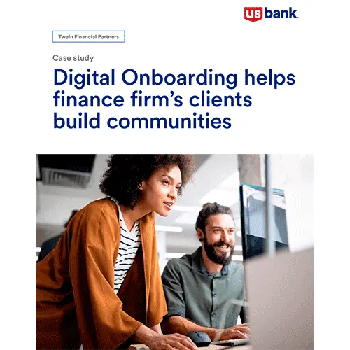 Man and woman smiling and looking at a computer screen together