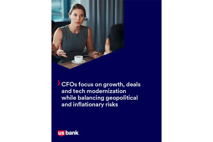 Woman seated at a desk with a coffee cup. Overlayed on the image are the words, CFOs focus on growth, deals and tech modernization while balancing geopolitical and inflationary risks