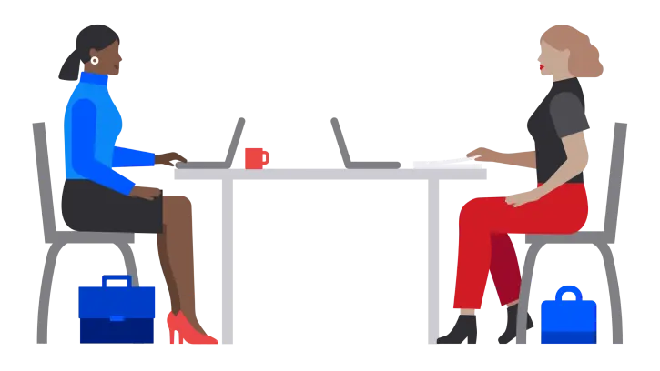 Computer users at table