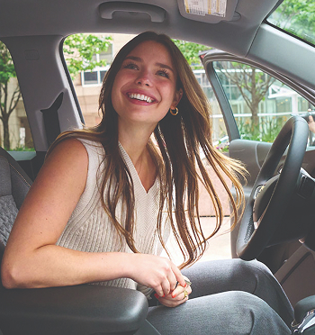 Woman smiling in her car