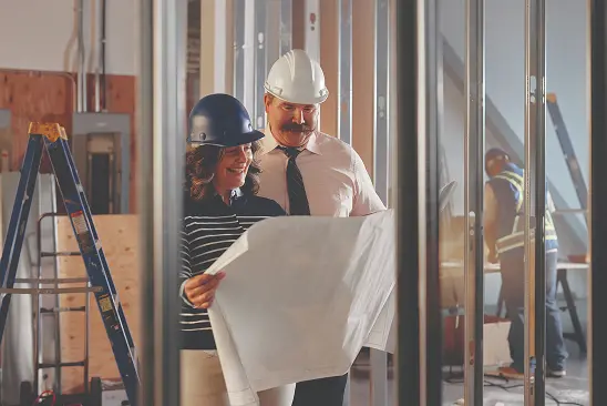 Builders looking at a blueprint