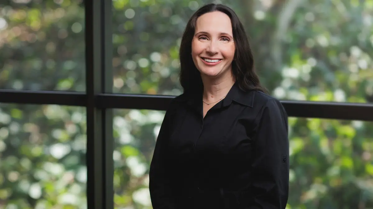 Woman smiling and facing the camera