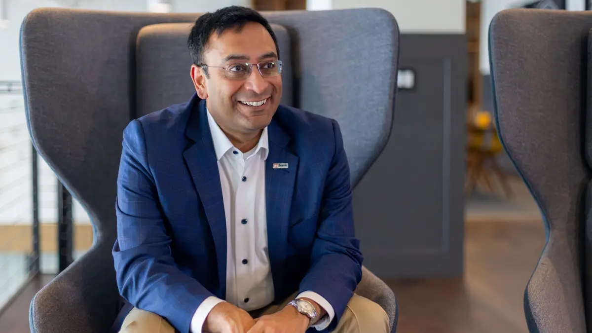 Man seated and smiling.