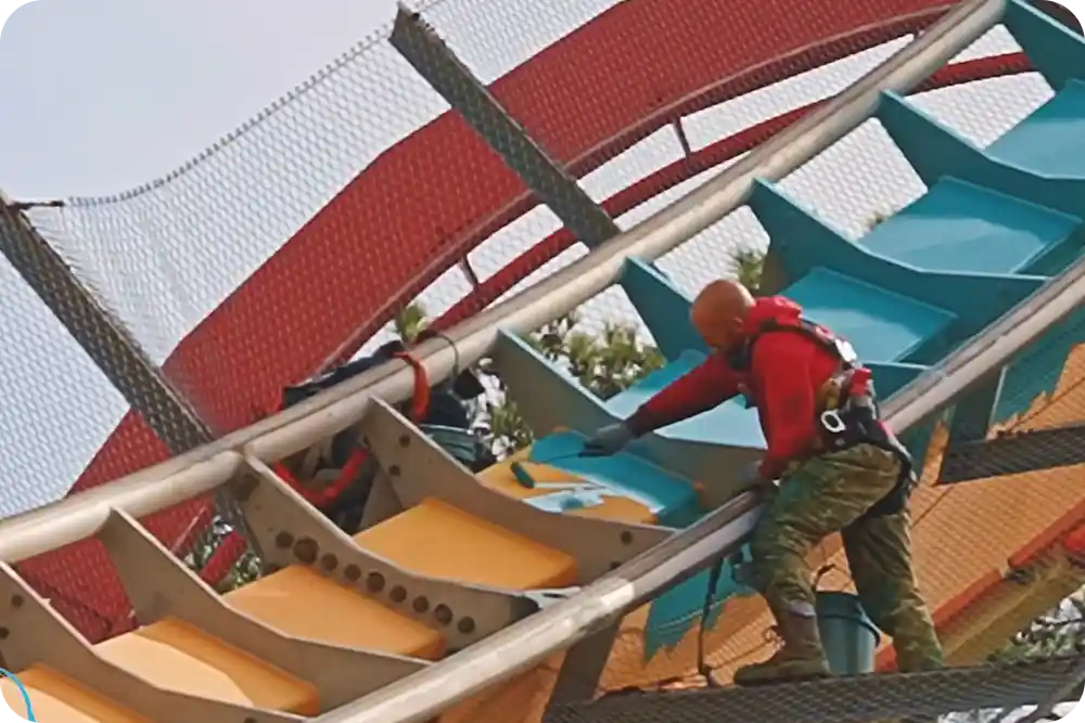 A man painting a roller coaster