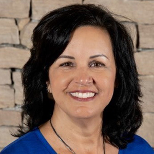 Headshot of a woman wearing a blue shirt