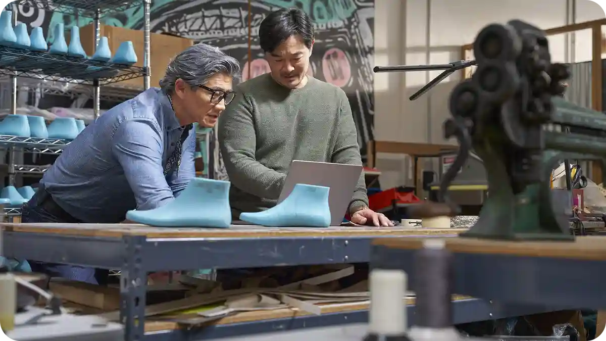 Two men in a manufacturing environment.