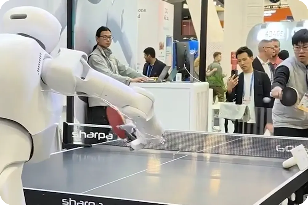 Robot and man playing ping pong.