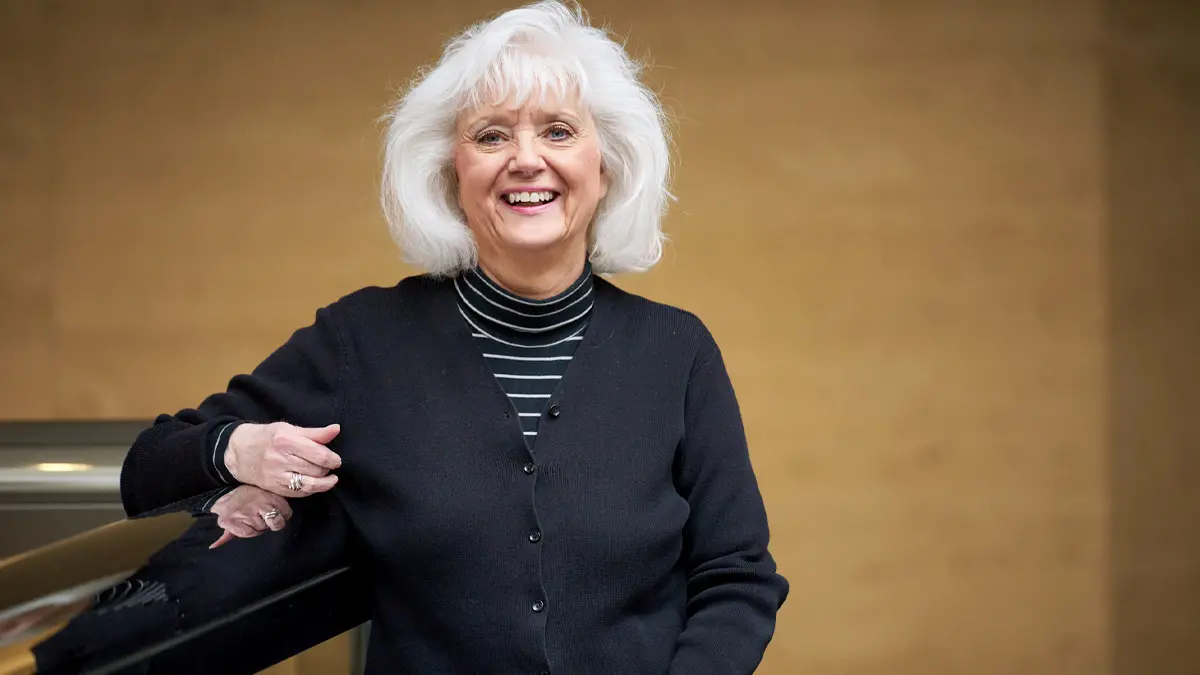 A woman standing and facing the camera.