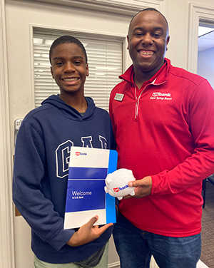 A man and boy standing together and facing the camera.