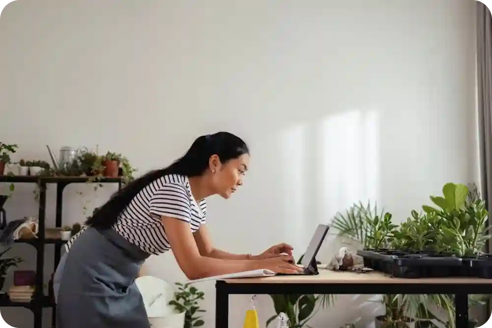 A female small business owner looking at her computer
