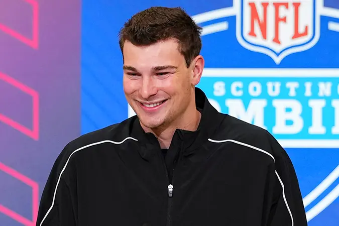 Fernando Mendoza smiles at an NFL event podium.