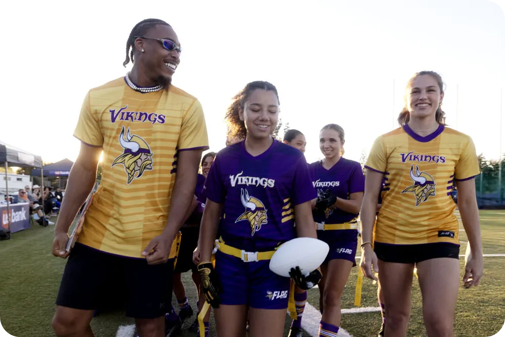 Flag football players walking on the field.