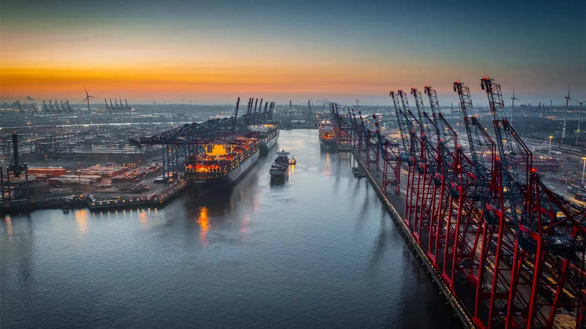 Photo of a busy shipping port at sunrise 
