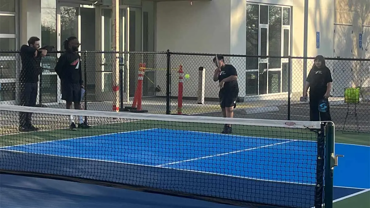 Photo of a young girl talking to a coach