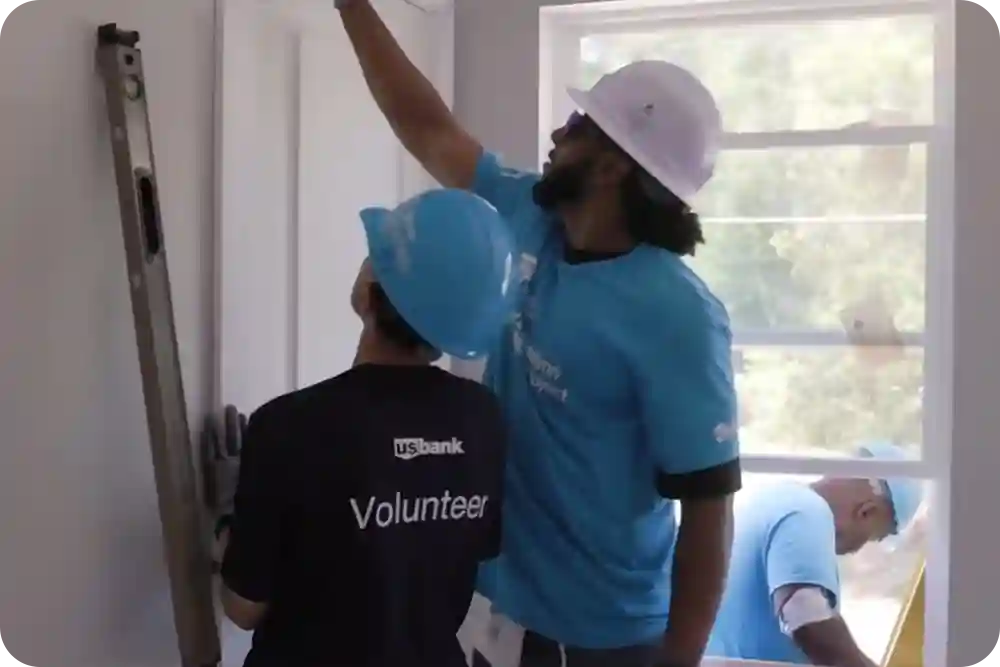 Photo of people wearing U.S. Bank volunteer shirts at a construction site