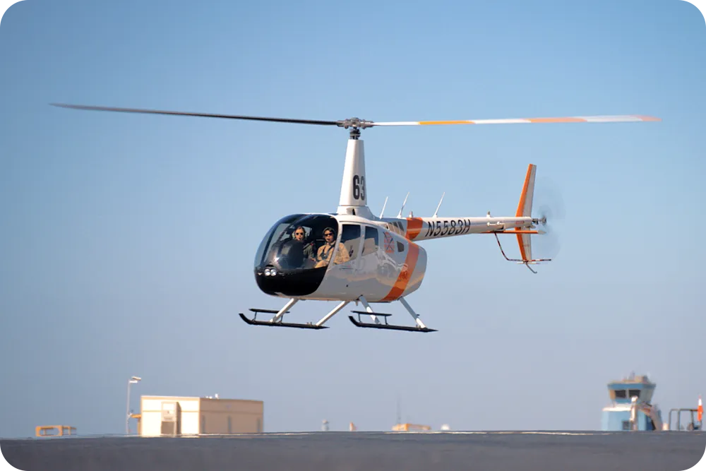 A helicopter flying above the ground.