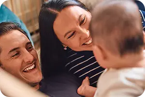 A man and woman with a baby.