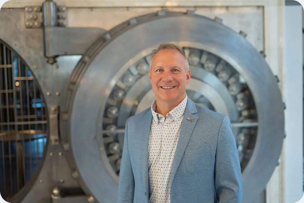 man standing near a bank vault