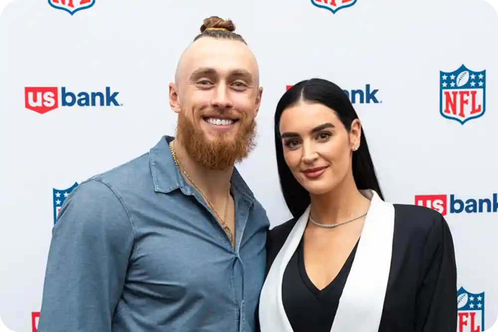 Man and woman smiling in front of a U.S. Bank sign