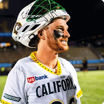 California Redwoods player wearing jersey featuring U.S. Bank logo is smiling after pulling his helmet up.