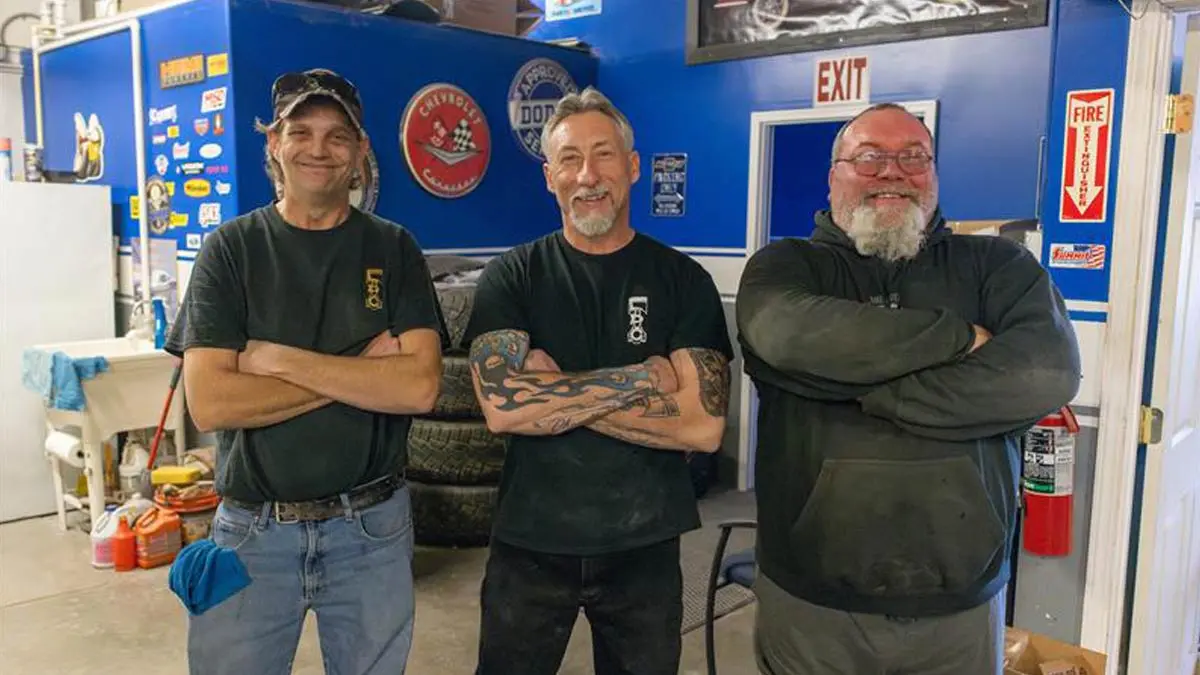 Photo of three men who work in an auto customization garage