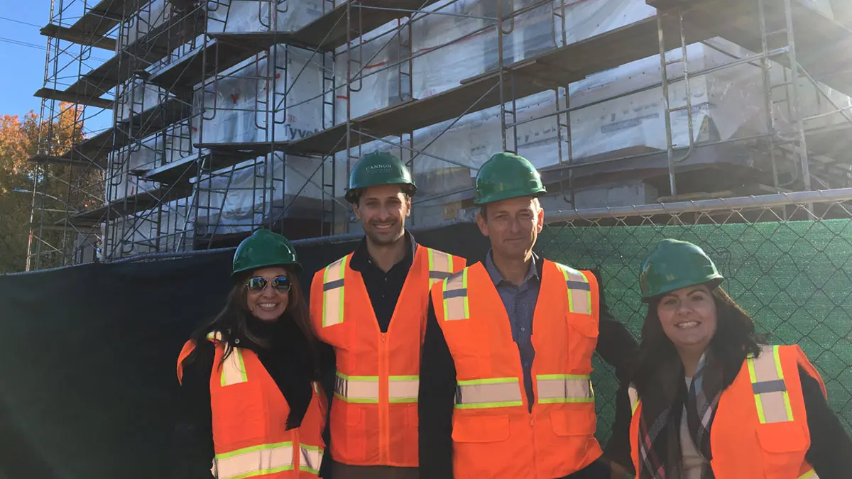 People in construction clothing at construction site. 