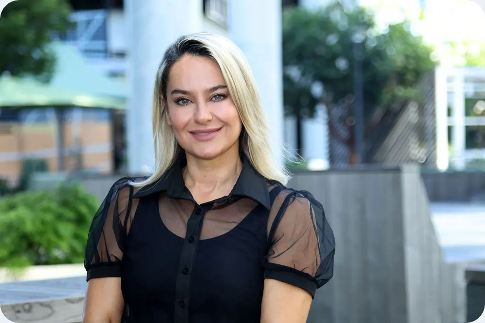 Woman standing outside smiling at the camera