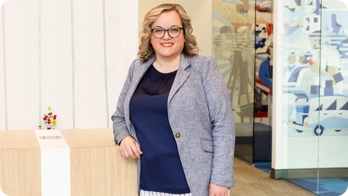 Woman standing and facing the camera.