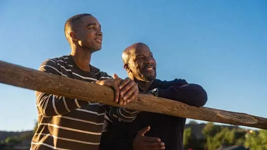 Father and son standing outside.
