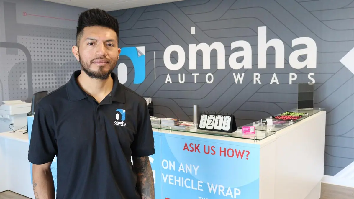 Business owner standing in front of Omaha Auto Wraps sign