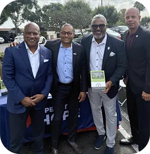 Four men standing side by side.