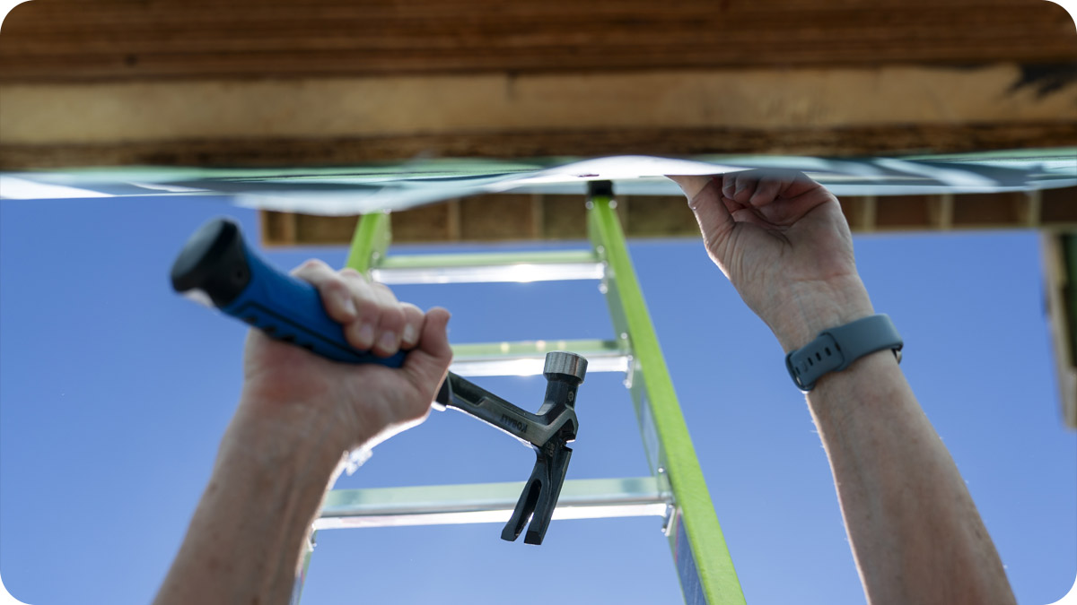 Photo of hands hammering in a nail