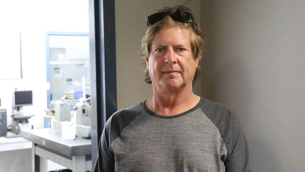 Three women in classroom setting.