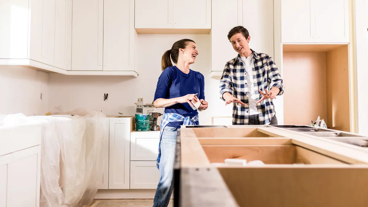 A couple in their kitchen, which is being remodeled.