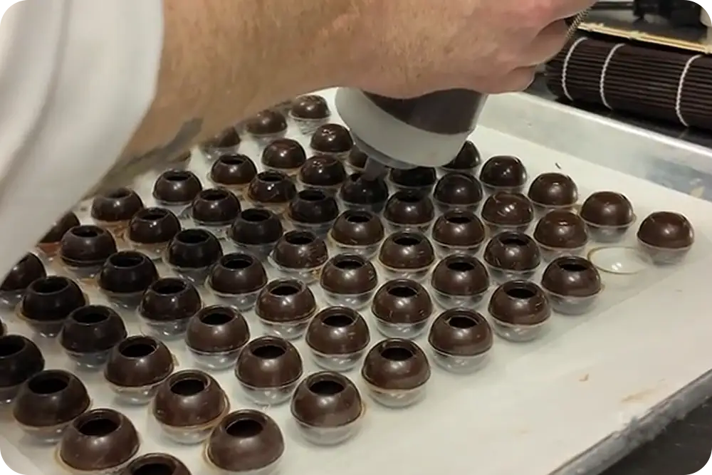 A chocolatier preparing chocolates