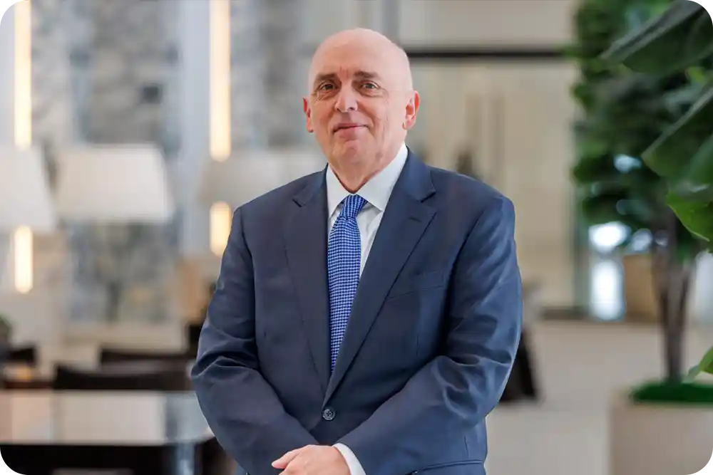 A man wearing a suit in an office lobby