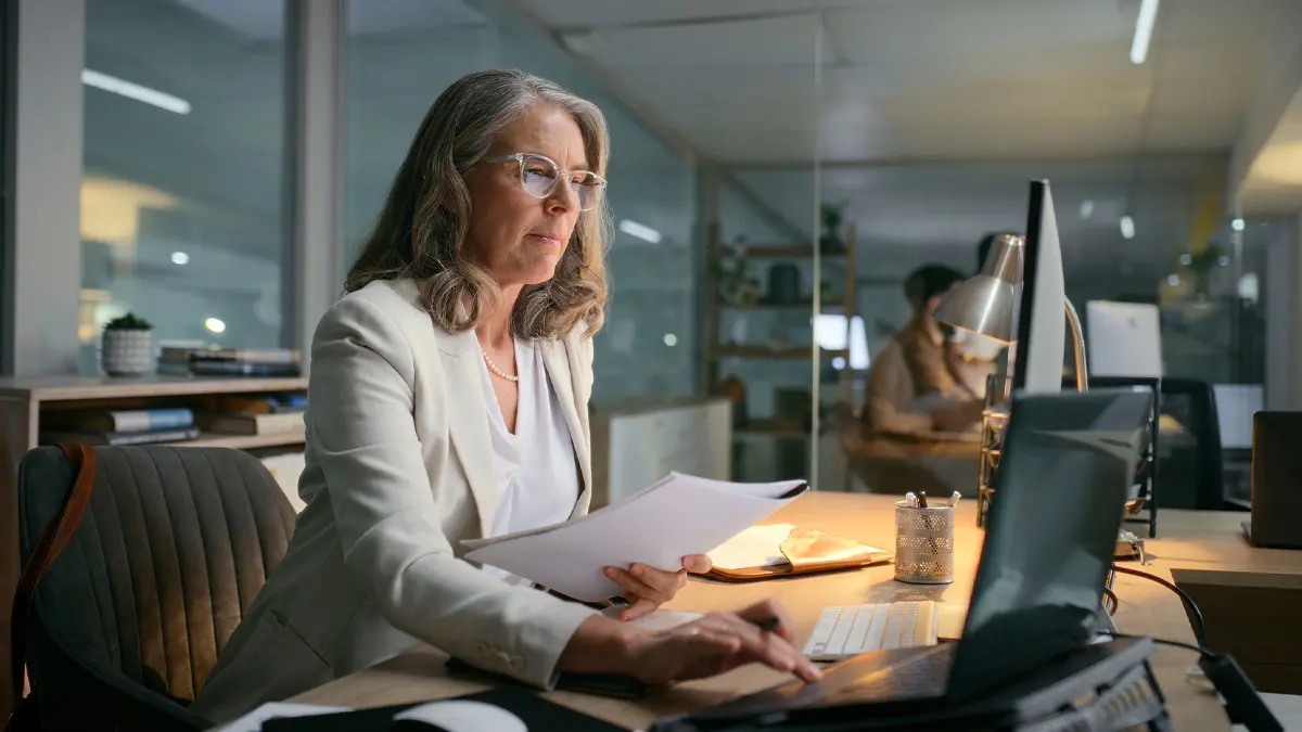 Woman in an office working at a desk.
