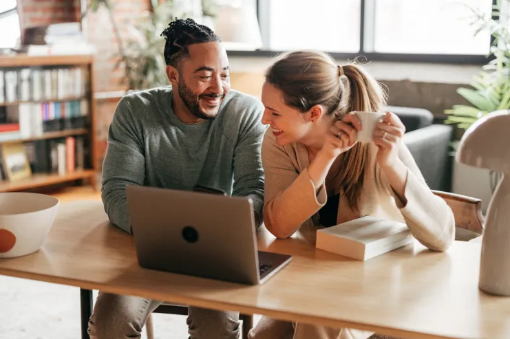 Photo of couple at desk reviewing budget