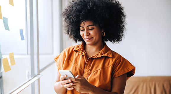 A woman using her new U.S. Bank Commercial Card, the Commercial Rewards Card, on her smartphone.
