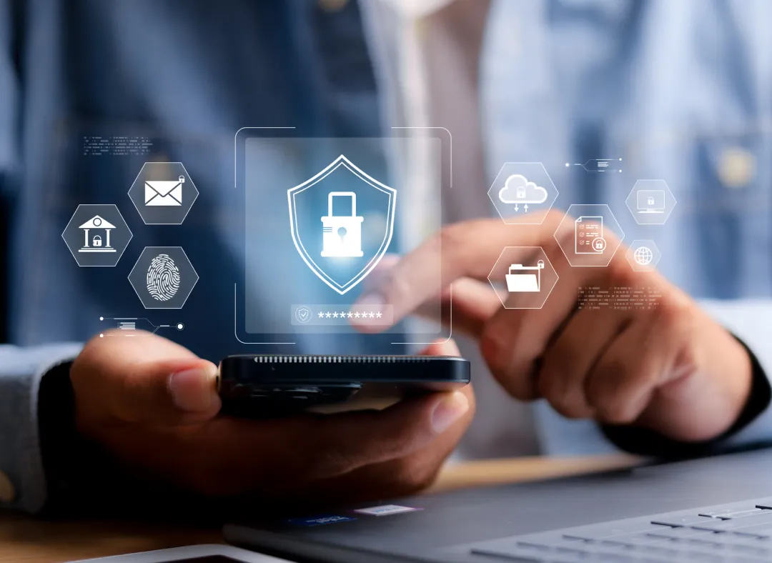 Closeup view of human hands using a smartphone with overlays of digital security icons, including a padlock, fingerprint and email
