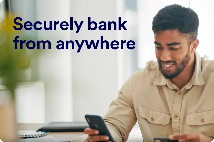 Man entering credit card information on a smartphone. Text on screen says “Security bank from anywhere”