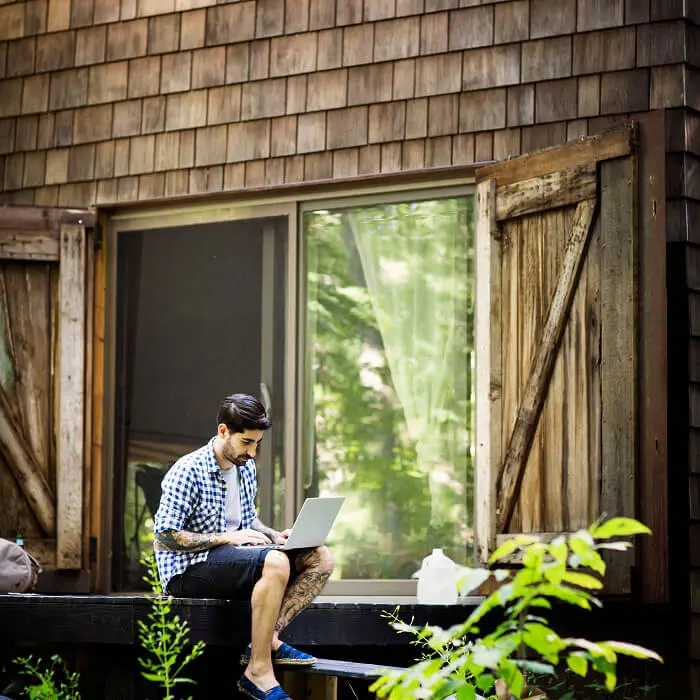 Couple sitting at table looking at computer