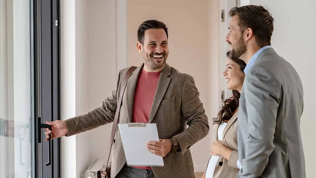 Two people at a door talking with a U.S. Bank correspondent and HFA lender.