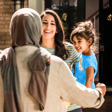 woman welcomes mother with hug