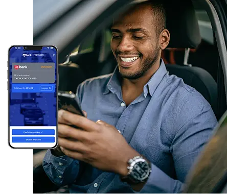Image of man using Voyager mobile app in wihle parked in their car. 