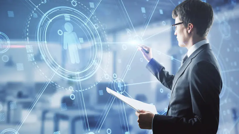 Young professional man in suit, holding a paper, and conducting a presentation about FX on a large screen