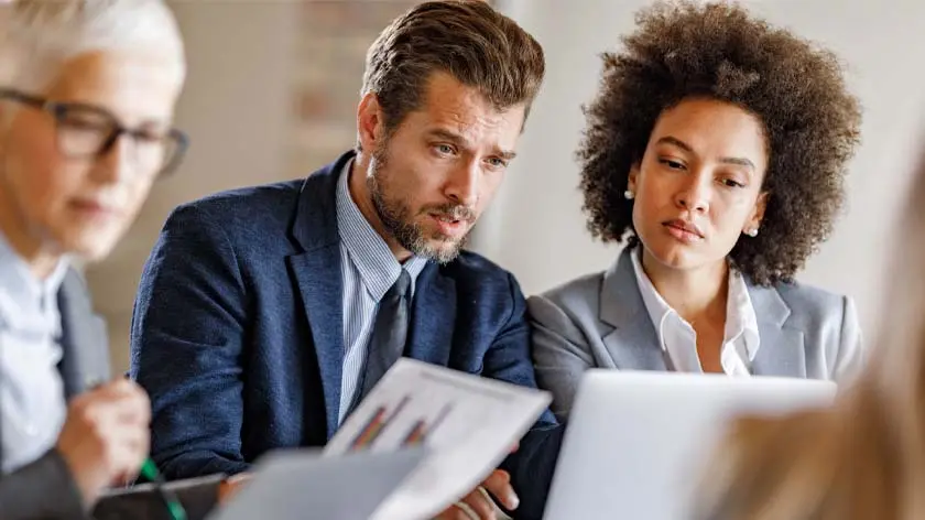 Man and woman looking at a computer as they discuss liquidity management 