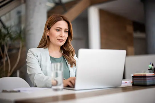 Woman at a laptop researching card fraud