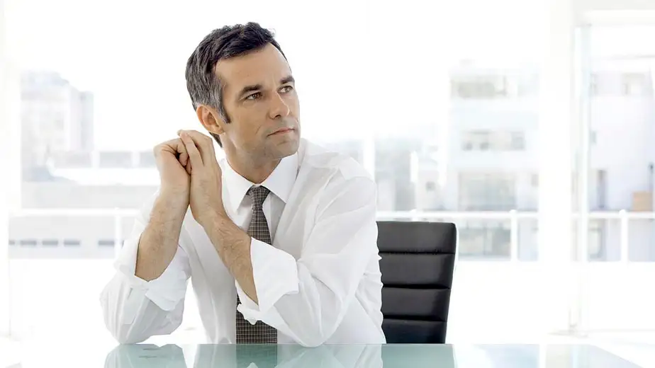 Man at desk in office, contemplating how to modernize ar billing processes with erp automation.