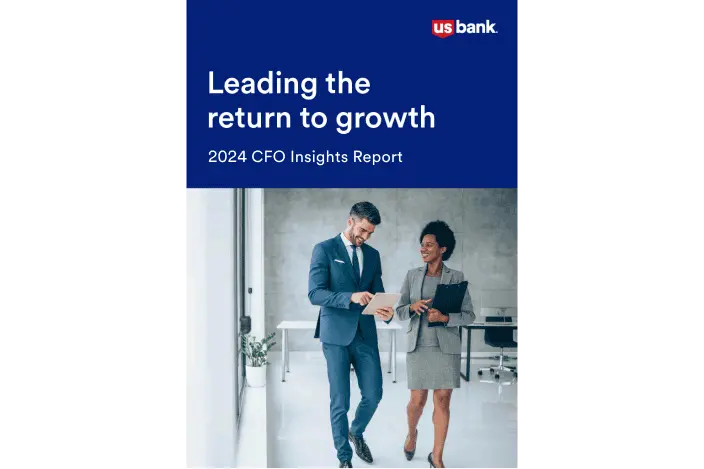 Two professionally dressed people walking down a hallway. The words “Leading the Return to Growth” are above them